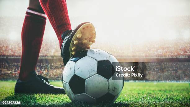 Feet Of Soccer Player Tread On Soccer Ball For Kickoff In The Stadium Stock Photo - Download Image Now