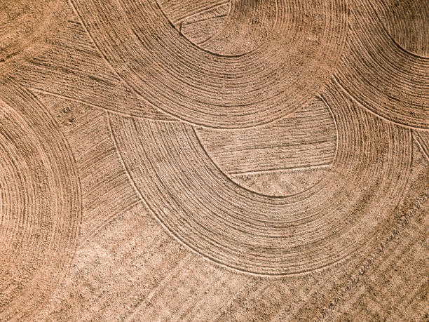 istock Spring arable land. Field and beautiful patterns from the tractor. View from above. 992900886