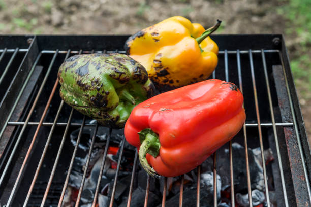 Peppers cook on the grill of barbecue