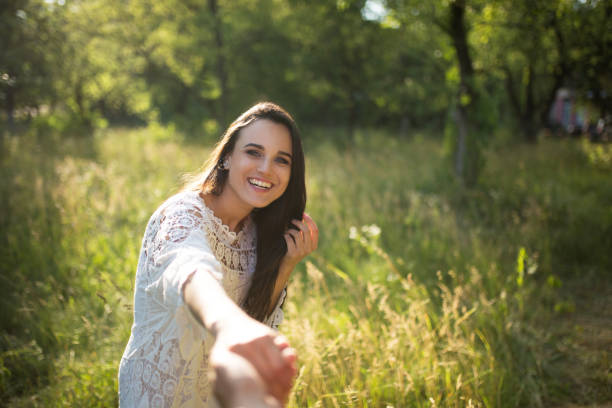 istock Girl in forest holding mans hand 992910230