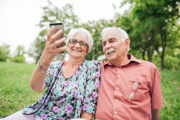 istock Smiling mature couple taking a selfie in the park 992910872