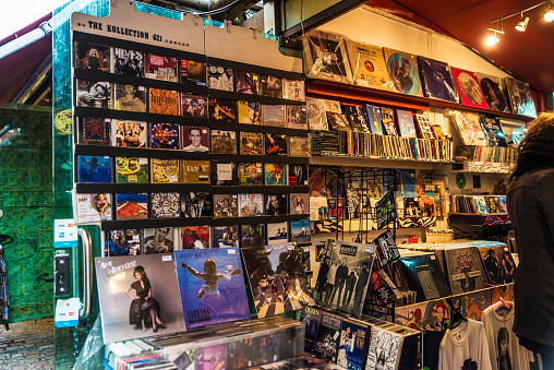 London, England UK  - December 31, 2017: Shop of vinyl records and music CD in Camden Lock Market or Camden Town with people around in London, England, United Kingdom