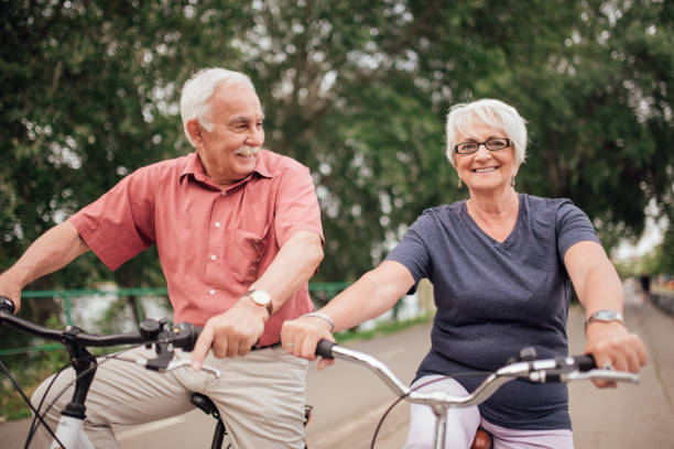 istock Senior couple riding a bike 992913406