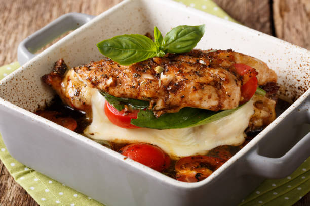 istock Balsamic chicken breast stuffed with mozzarella, basil and tomatoes close up. horizontal 992914212