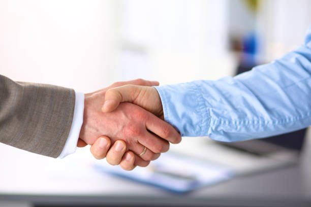 istock Business handshake. Two businessman shaking hands with each other in the office 992923574