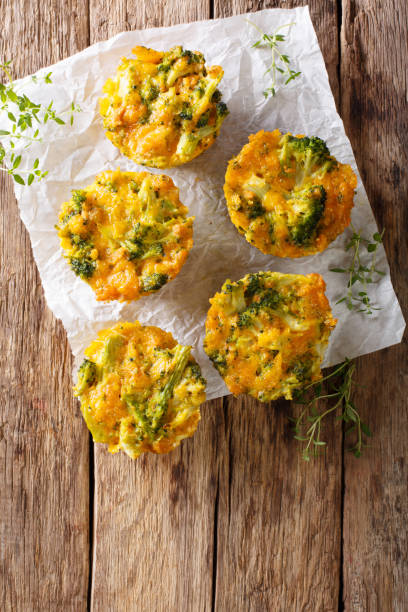istock Broccoli Muffins with cheddar cheese and thyme close-up on the table. vertical top view 992925006
