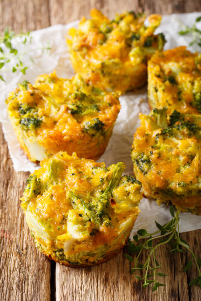 istock Healthy snack Broccoli muffins with cheddar cheese and thyme close-up. Vertical 992925210