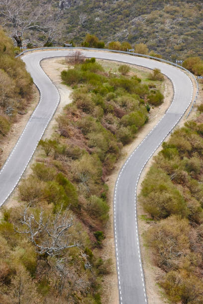 istock Empty curved asphalt mountain road. Rural scenic travel 992935520