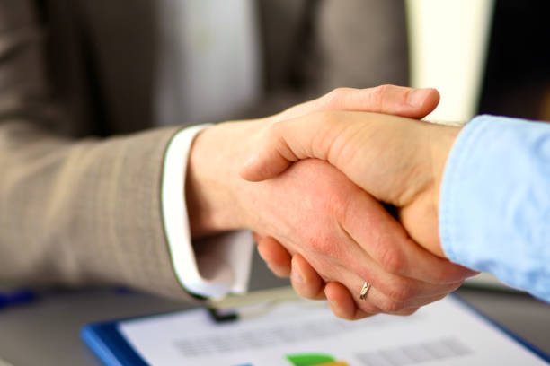 istock Business handshake. Two businessman shaking hands with each other in the office 992935892