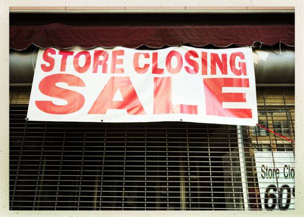 istock Store Closing Sign  and Metal Gate 992943152