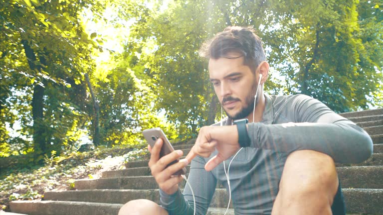 Athletic men using his mobile phone.