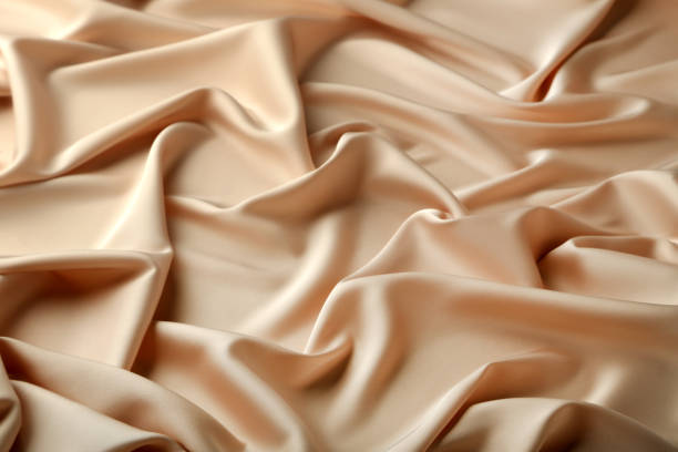 istock Background of beige satin fabric 992954938
