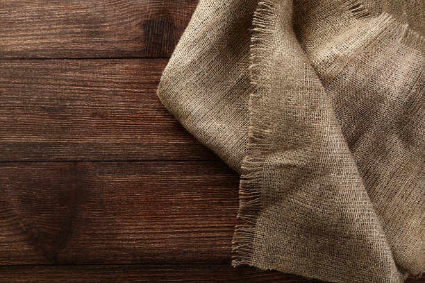 istock Sackcloth texture on brown wooden table 992956566