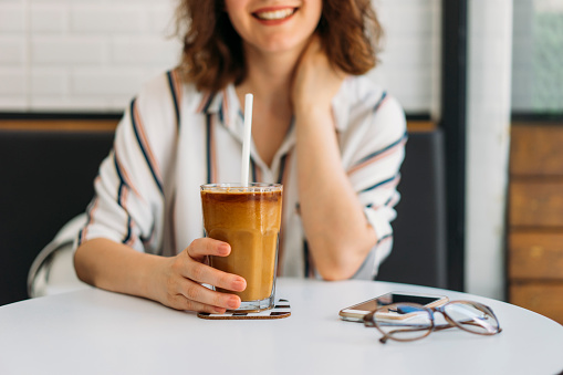 Woman drinking iced coffee