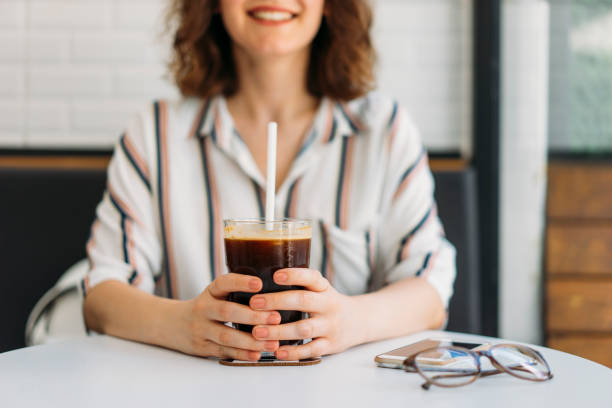 Woman drinking iced coffee