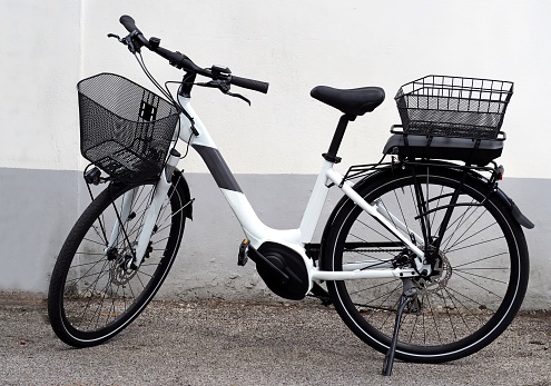 Brand new electric bicycle, or e-bike, for women. The new battery is thin enough to be placed under the back basket .