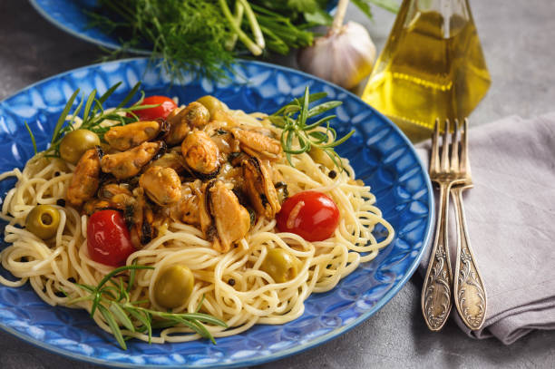 istock Spaghetti with mussels and tomatoes. on grey background. 992959860