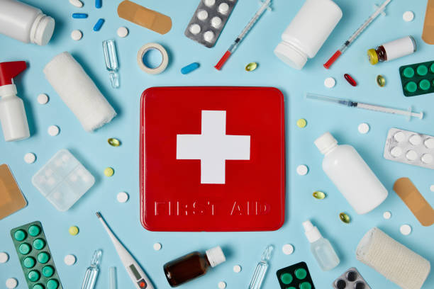 istock top view of red first aid kit box on blue surface surrounded with different medicines 992960764