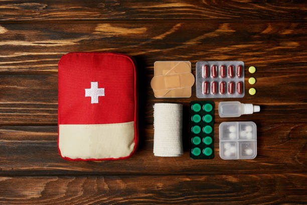 istock top view of first aid kit composed with various pills and bandage on wooden tabletop 992965980