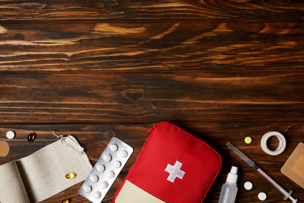 istock top view of first aid kit with different medicines on wooden tabletop 992968238