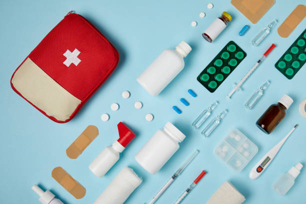 istock top view of first aid kit bag with composed medicines on blue surface 992970604