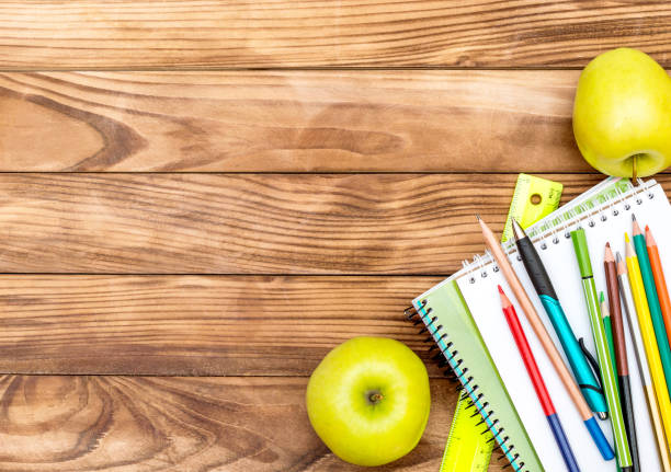 istock School supplies with apples on wooden background. Space for text. 992979670