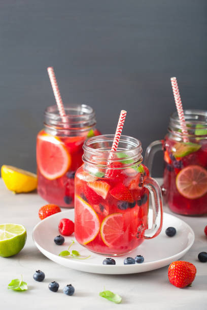 istock summer berry lemonade with lime and mint in mason jar 992981262