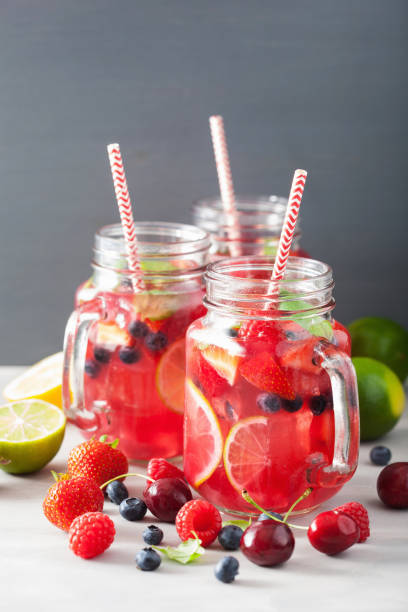 istock summer berry lemonade with lime and mint in mason jar 992981906