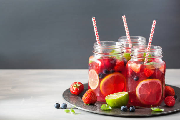 istock summer berry lemonade with lime and mint in mason jar 992982168