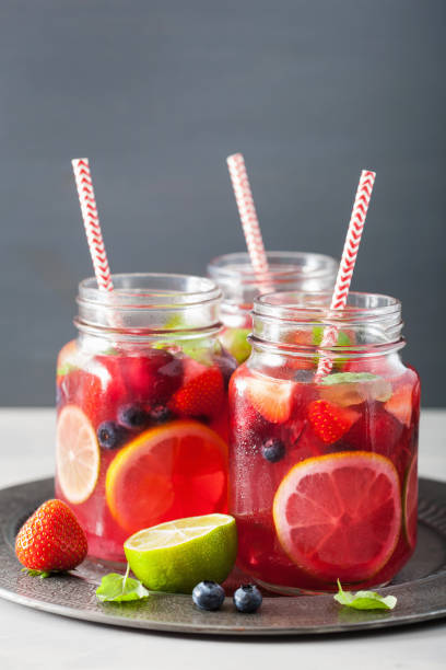 istock summer berry lemonade with lime and mint in mason jar 992982556