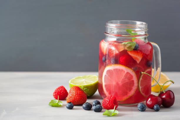 istock summer berry lemonade with lime and mint in mason jar 992985014