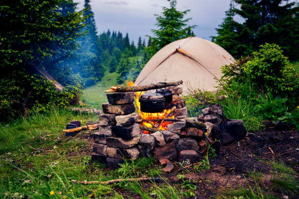 istock Old smoky pots is heated on a bright bonfire 992999284