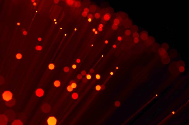 istock red fiber optic abstract background on black. 993003396