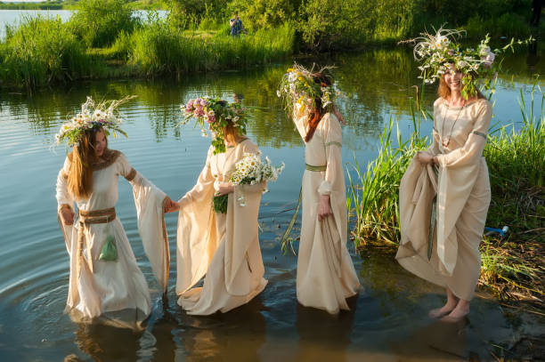Beautiful women with flower wreath in water stock photo