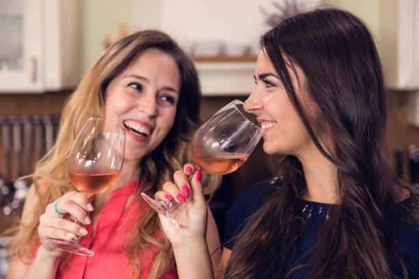 istock Young happy women drinking wine and having fun together. 993021000