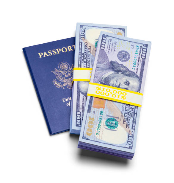 Passport with Stack of Cash USA Passport with Stacks of Cash Isolated on a White Background. blue us passport cover stock pictures, royalty-free photos & images