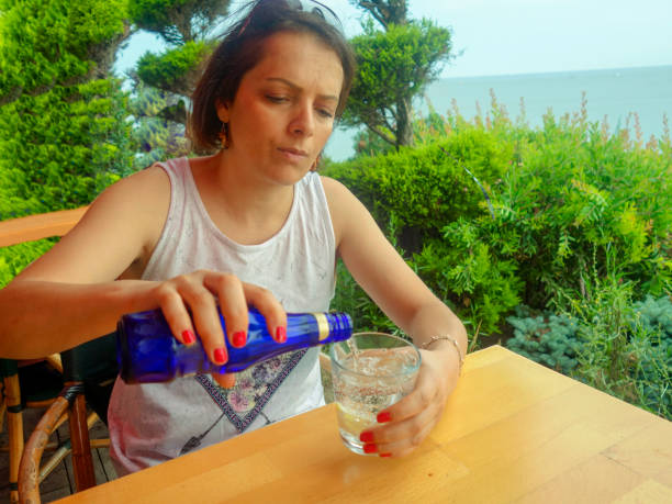 Adult women drink soda from bottle