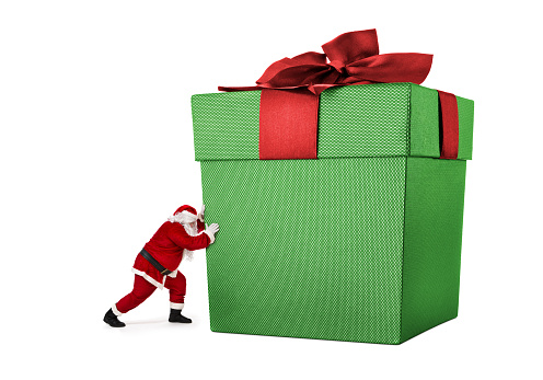 Close up of Santa Claus pushing huge gift box full of presents isiolated on white background