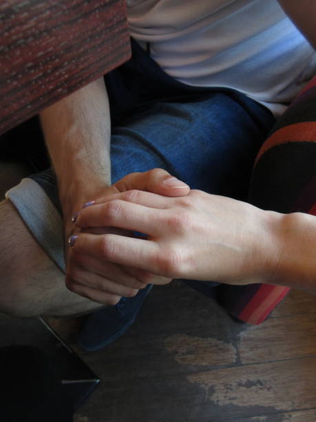 istock Couple holding hands in a restaurant 993073948