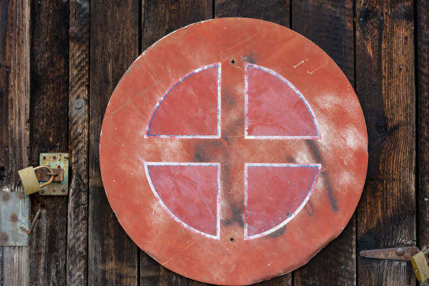 old red weathered street sign on brown wood wall