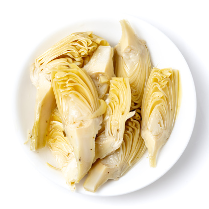 Quartered Artichoke hearts from above on white background