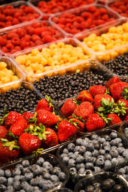 istock Colourful mix of different fresh berries at market 993085658