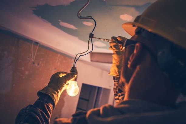 Working Contractor Electrician Working Contractor Electrician. Fixing the Light. electrician stock pictures, royalty-free photos & images