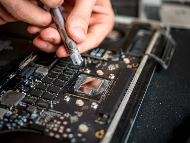 istock close up hands with thermal paste apply it to laptop cooler system 993089832