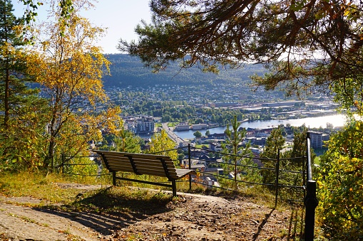 The view of Drammen from a bench in the hillside above the city. Autumn colors in Norway.