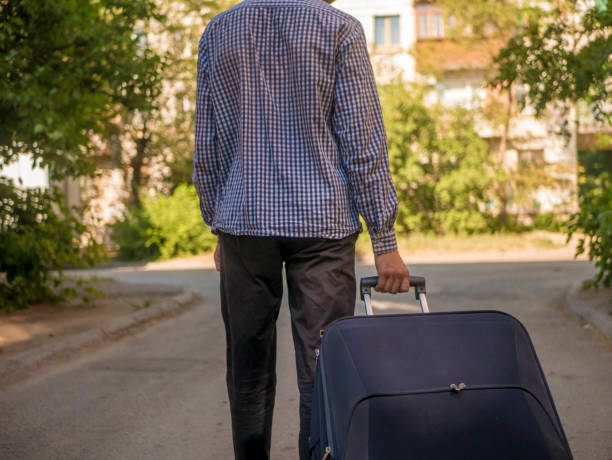 istock back view of person pulling big suitcase traveling in europe 993094036