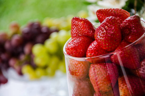 Fruit background of strawberries, grapes and blue berries.