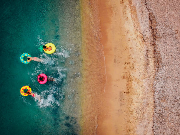 fidanzate che si divertono sui galleggianti in acqua - travel luxury aerial view beach foto e immagini stock