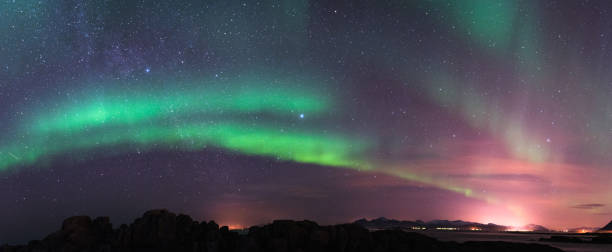 aurora borealis and milky way - tromso fjord winter mountain imagens e fotografias de stock