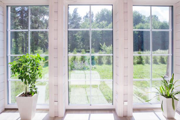 istock Bright photo studio interior with big window, high ceiling, white wooden floor 993114128